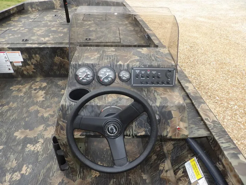 Slide: The Image of 2025 Crestliner 2070 Retriever SCHD boat dashboard with camouflage design and steering wheel. - 15