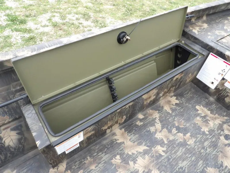 Slide: The Image of 2025 Crestliner 2070 Retriever SCHD boat storage compartment with camouflage design. - 24