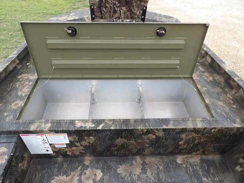 Slide: The Image of 2025 Crestliner 2070 Retriever SCHD boat storage compartment with camouflage design. - 26