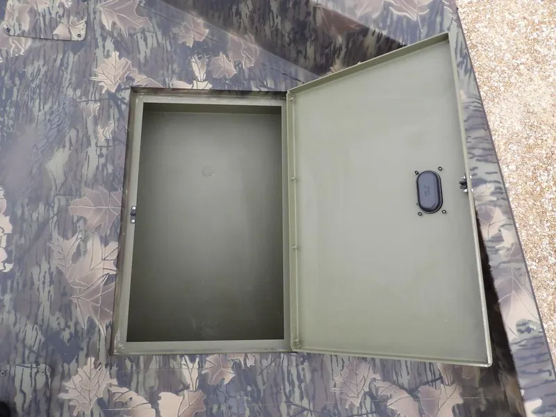 Slide: The Image of 2025 Crestliner 2070 Retriever SCHD storage compartment with camouflage pattern. - 28