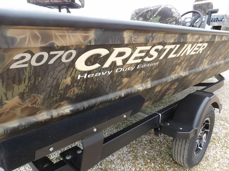 Slide: The Image of 2025 Crestliner 2070 Retriever SCHD boat with camouflage design on trailer. - 37