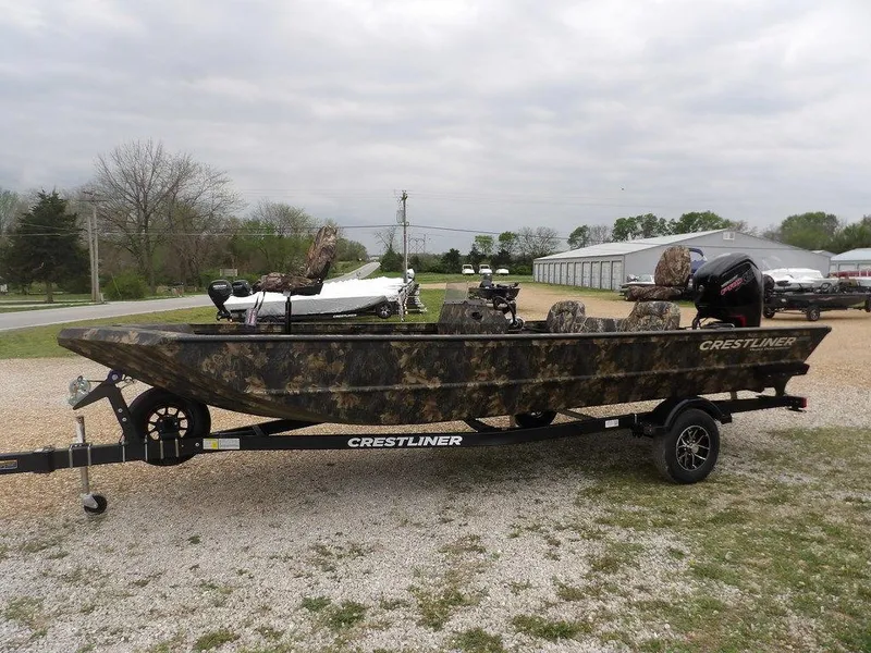 Slide: The Image of 2025 Crestliner 2070 Retriever SCHD boat with camouflage design on a trailer. - 4