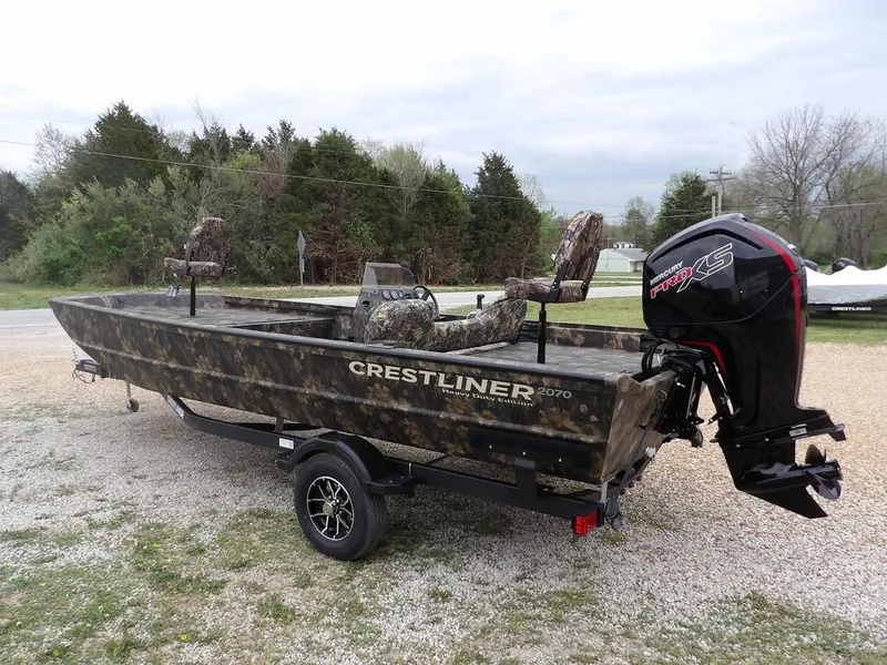 Slide: The Image of 2025 Crestliner 2070 Retriever SCHD boat with camo design and powerful outboard motor. - 6