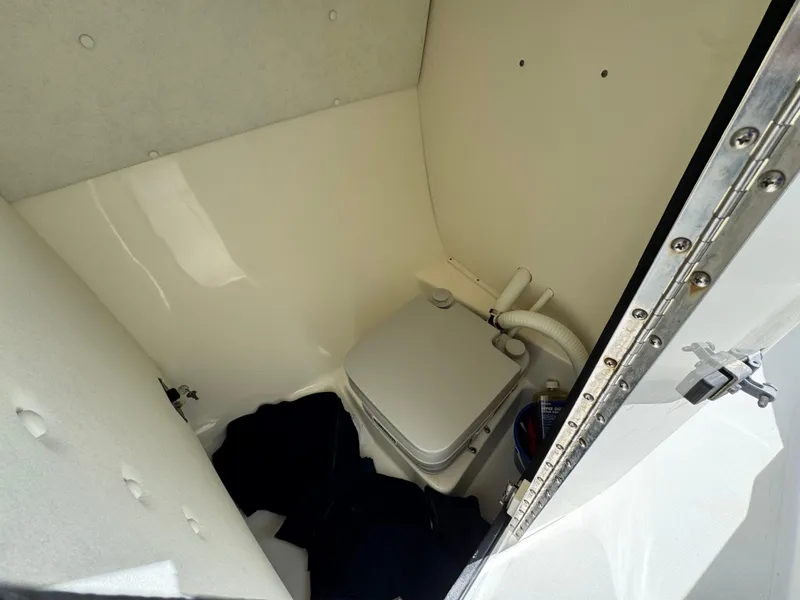 Slide: The Image of 2005 Boston Whaler 210 Ventura boat interior with compact marine toilet. - 11