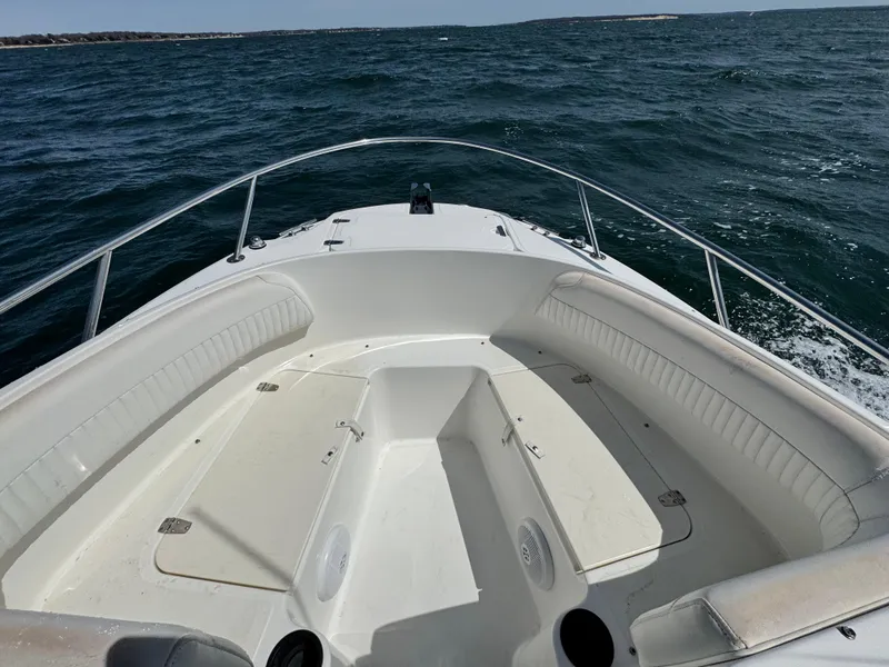 Slide: The Image of 2005 Boston Whaler 210 Ventura boat on open water, showcasing spacious bow seating. - 13