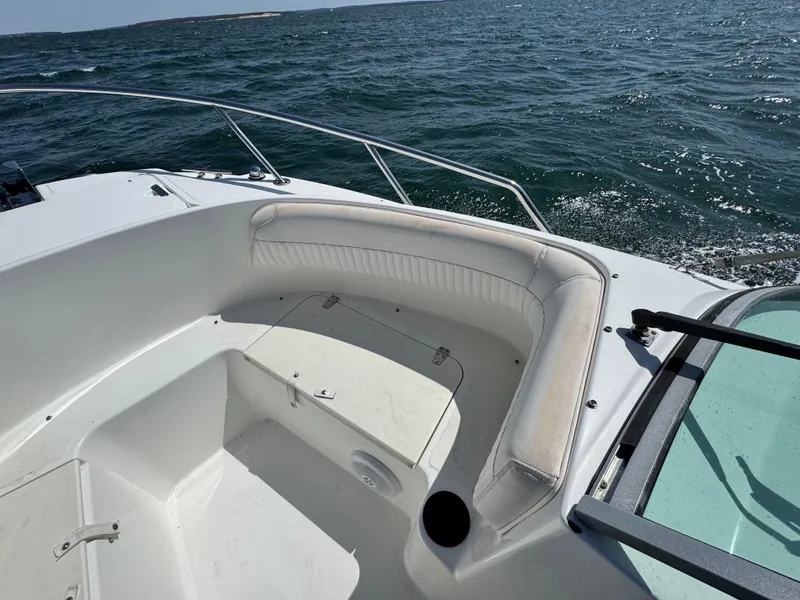Slide: The Image of 2005 Boston Whaler 210 Ventura boat interior with seating, on open water. - 14