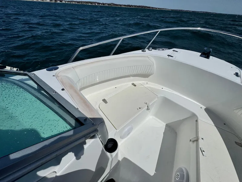 Slide: The Image of 2005 Boston Whaler 210 Ventura boat on open water, featuring spacious seating area. - 16