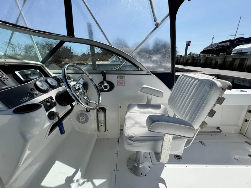 Slide: The Image of 2005 Boston Whaler 210 Ventura boat cockpit with steering wheel and captain's chair. - 6
