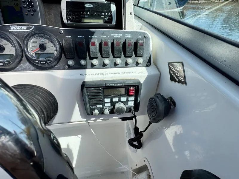 Slide: The Image of Control panel of a 2005 Boston Whaler 210 Ventura boat with gauges and radio equipment. - 8