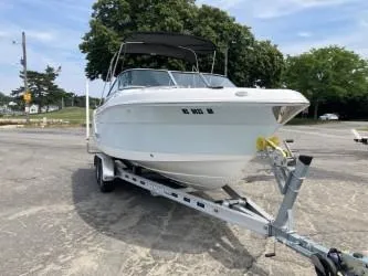 Slide: The Image of 2016 Robalo R227 Dual Console boat on trailer, parked outdoors. - 21