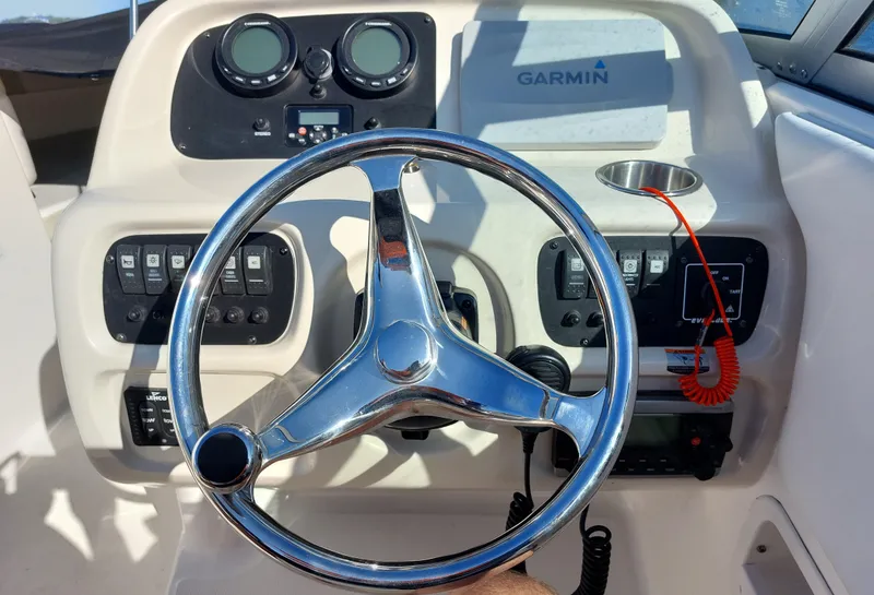 Slide: The Image of Steering wheel and dashboard of 2016 Robalo R227 Dual Console boat with Garmin system. - 25
