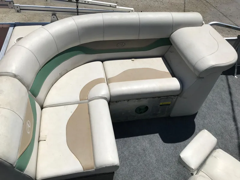Slide: The Image of 2009 Avalon Eagle 16' boat seating with beige and green upholstery. - 16