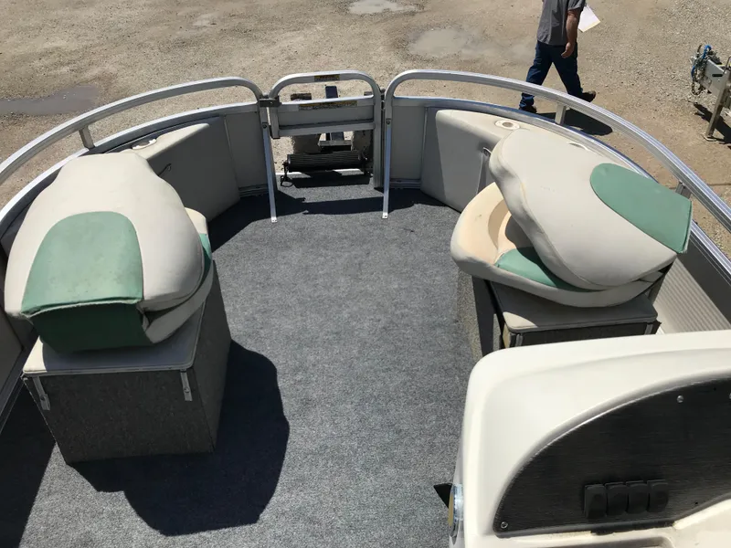 Slide: The Image of 2009 Avalon Eagle 16' pontoon boat interior with cushioned seating and carpeted floor. - 17