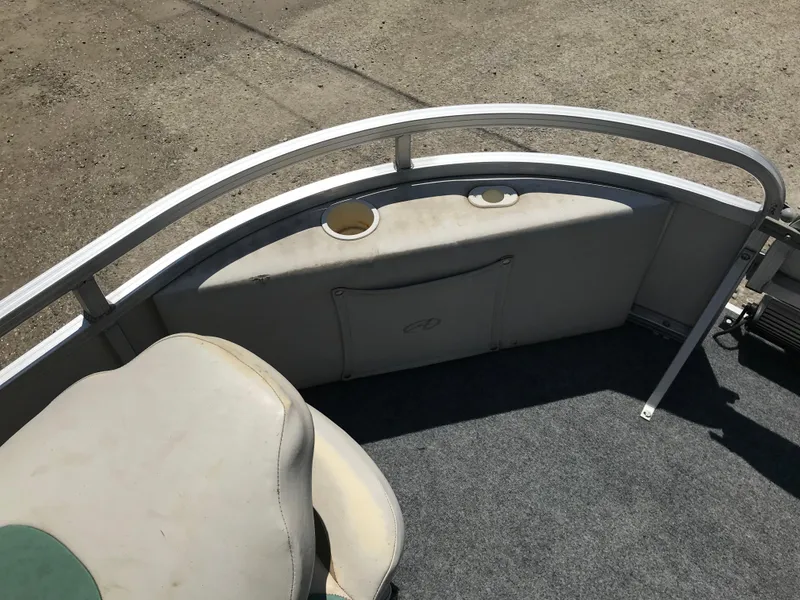 Slide: The Image of 2009 Avalon Eagle 16' boat interior with seating and railing, featuring cup holders. - 18