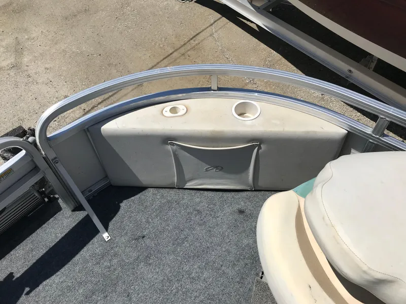 Slide: The Image of 2009 Avalon Eagle 16' boat interior with seating and cup holders. - 19