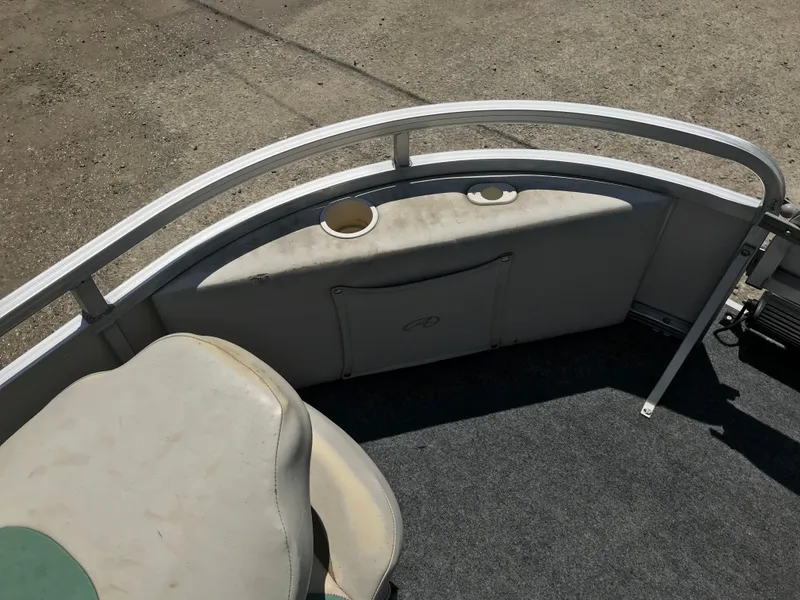 Slide: The Image of 2009 Avalon Eagle 16' boat interior with seating and cup holders. - 20