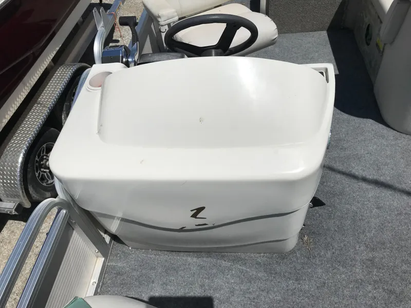 Slide: The Image of 2009 Avalon Eagle 16' boat interior with steering wheel and seating area. - 21