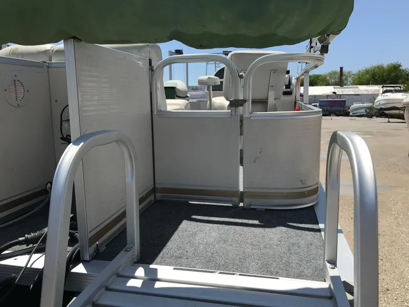 Slide: The Image of 2009 Avalon Eagle 16' pontoon boat with open gate and carpeted deck. - 26