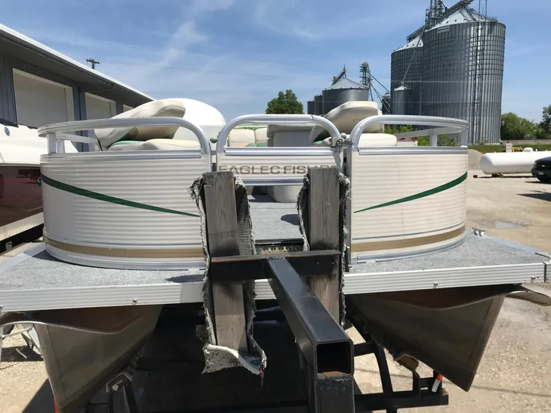 Slide: The Image of 2009 Avalon Eagle 16' pontoon boat on trailer, industrial background. - 3