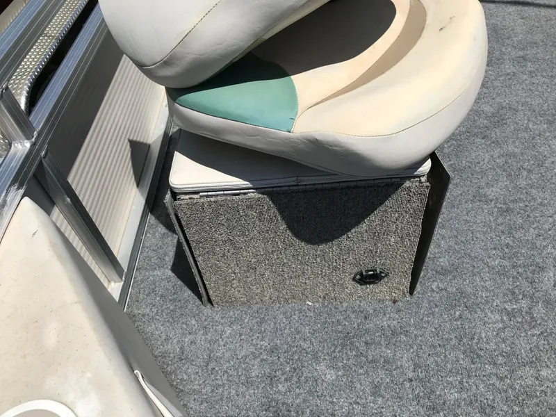 Slide: The Image of 2009 Avalon Eagle boat seat and storage compartment on carpeted deck. - 8