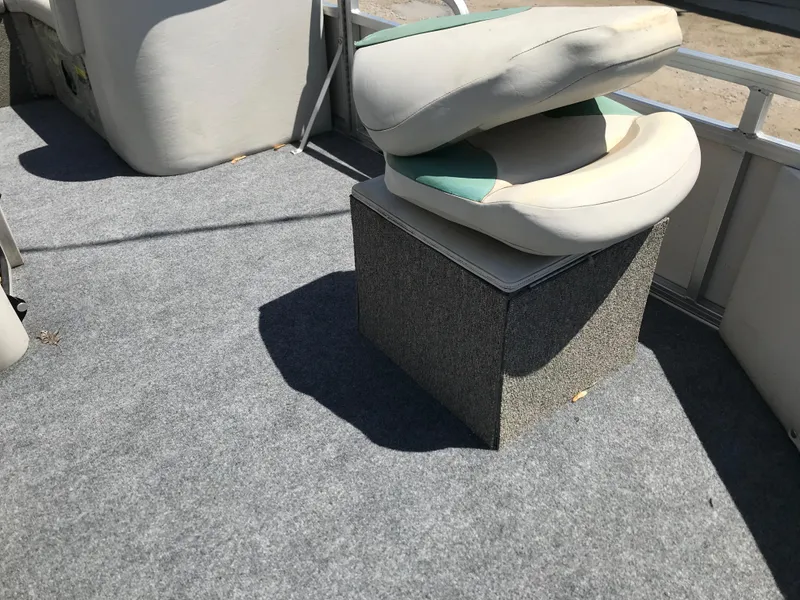 Slide: The Image of 2009 Avalon Eagle 16' boat interior with cushioned seating and carpeted flooring. - 9