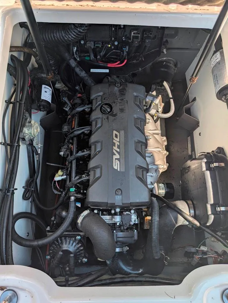 Slide: The Image of 2021 Yamaha Boats 195 FSH Sport engine compartment with visible components and wiring. - 11
