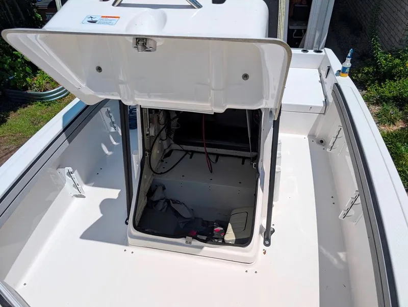 Slide: The Image of 2021 Yamaha Boats 195 FSH Sport open storage compartment, showcasing interior space and design. - 18