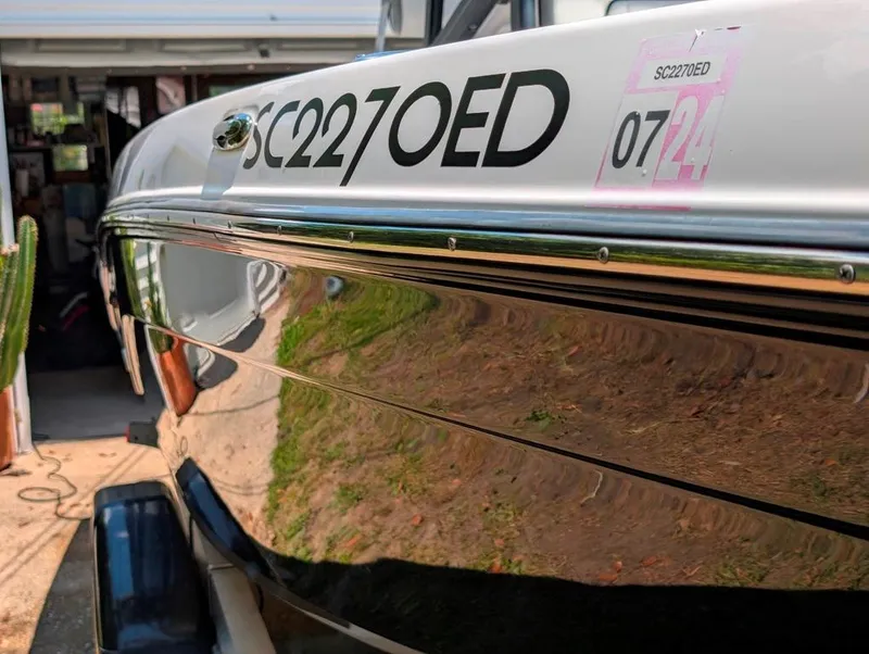 Slide: The Image of 2021 Yamaha Boats 195 FSH Sport with registration SC227OED, parked in a driveway. - 34