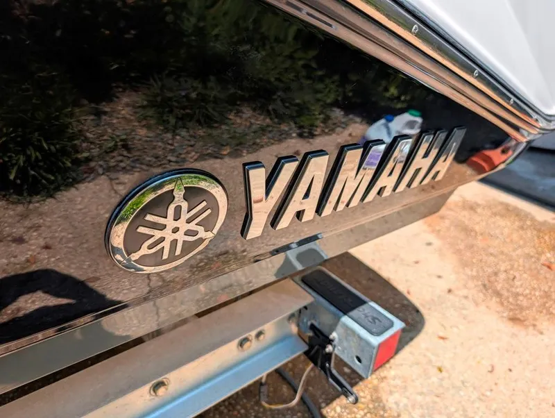 Slide: The Image of Close-up of 2021 Yamaha Boats 195 FSH Sport logo on boat exterior. - 38