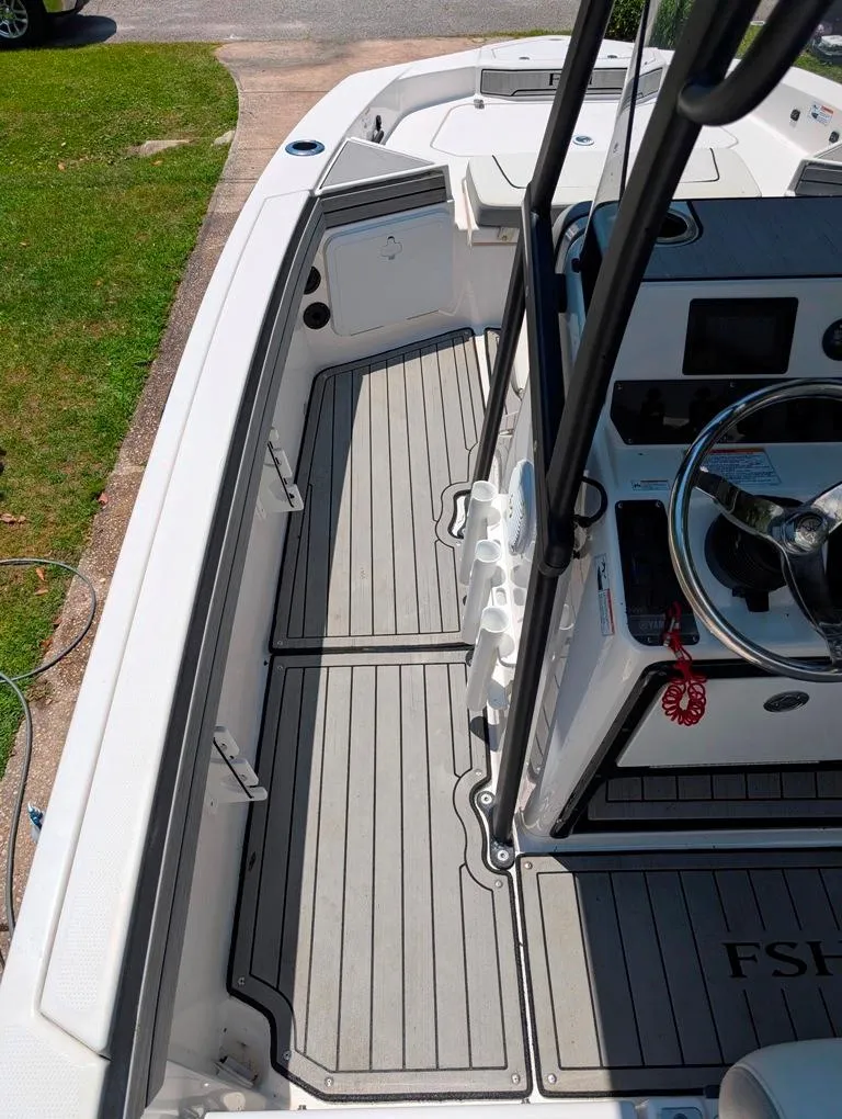 Slide: The Image of 2021 Yamaha Boats 195 FSH Sport interior with steering wheel and deck view. - 41