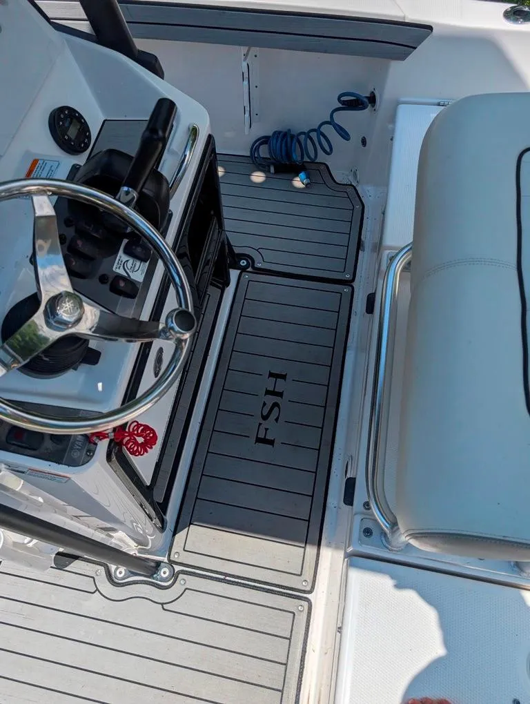 Slide: The Image of 2021 Yamaha Boats 195 FSH Sport interior with steering wheel and seating. - 42