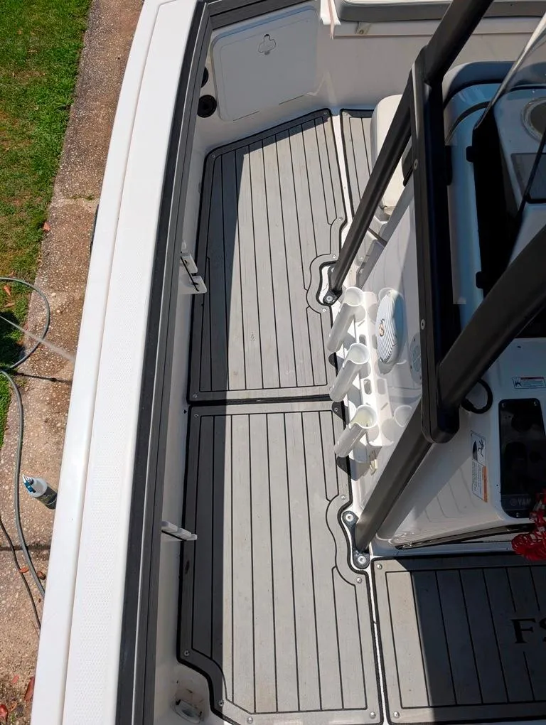 Slide: The Image of 2021 Yamaha Boats 195 FSH Sport deck with rod holders and non-slip flooring. - 43