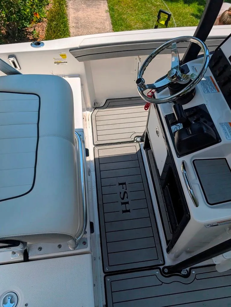 Slide: The Image of 2021 Yamaha Boats 195 FSH Sport interior with steering wheel and seating. - 45