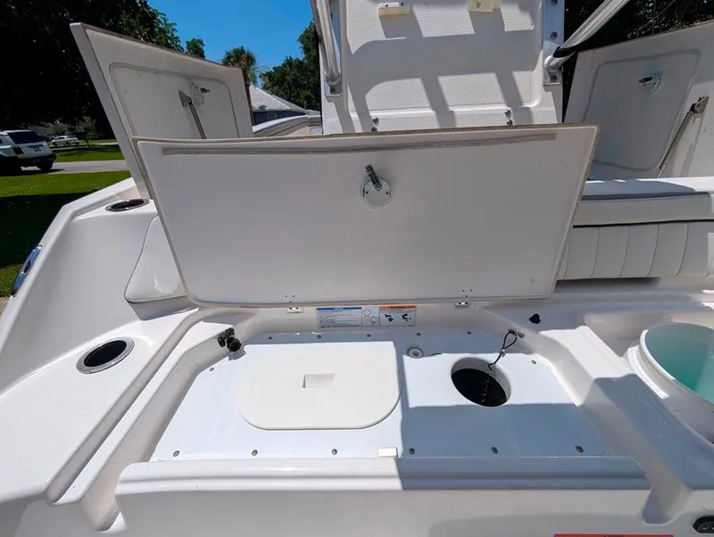 Slide: The Image of 2021 Yamaha Boats 195 FSH Sport open storage compartments on deck. - 8