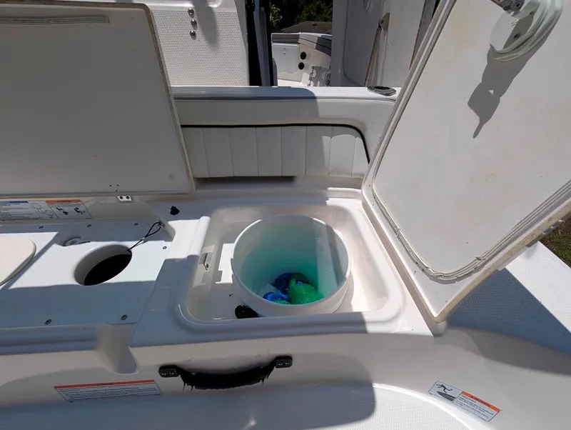 Slide: The Image of 2021 Yamaha Boats 195 FSH Sport livewell with open lid, showcasing interior storage. - 9