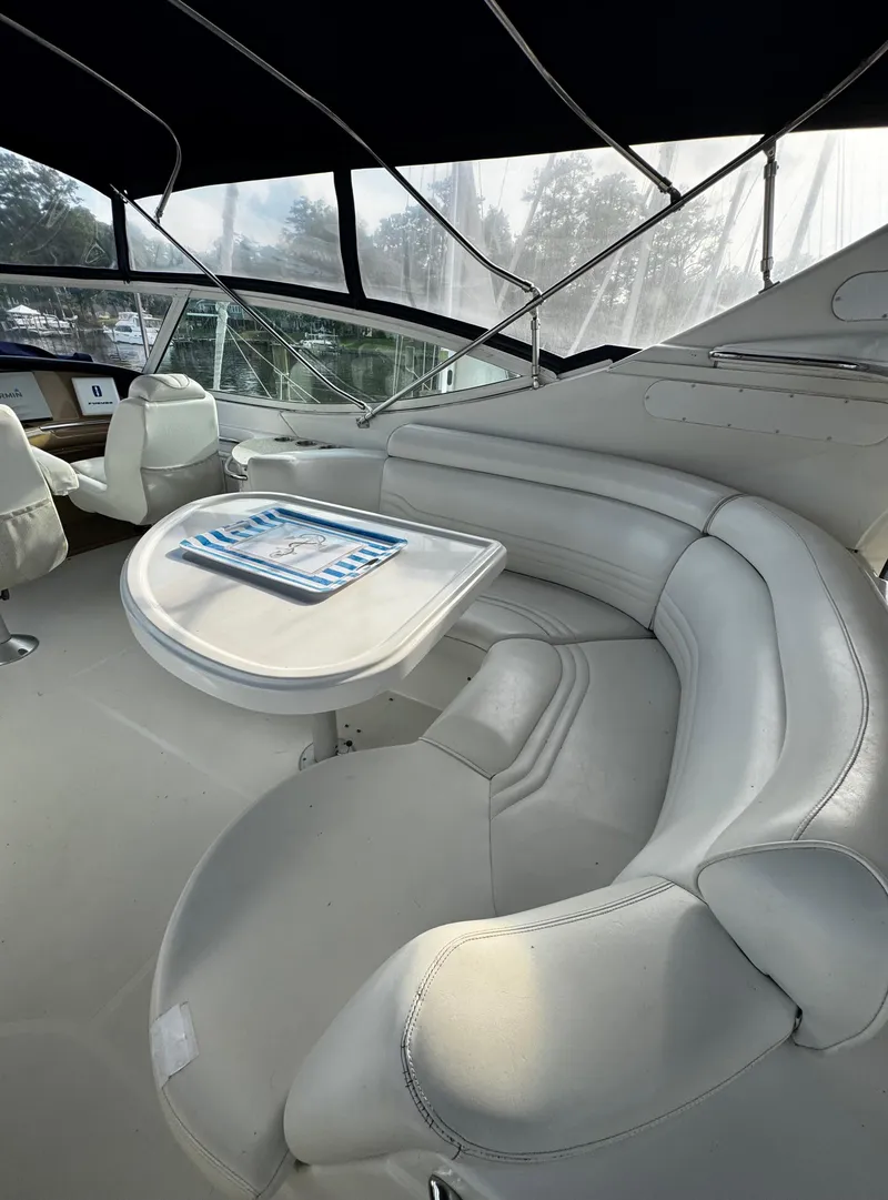 Slide: The Image of 2001 Carver 466 Motor Yacht interior with plush seating and table. - 25