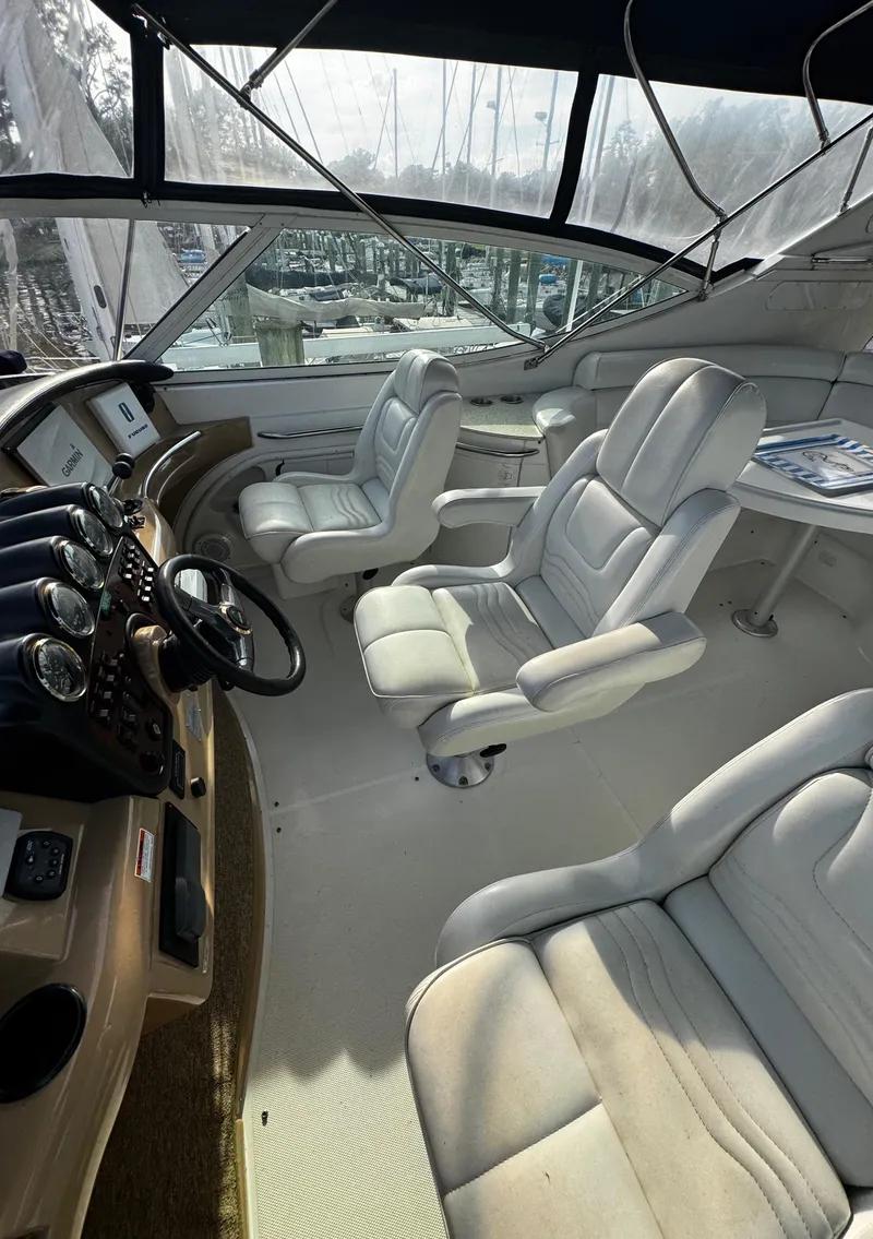 Slide: The Image of Interior of 2001 Carver 466 Motor Yacht with plush seating and control panel. - 27