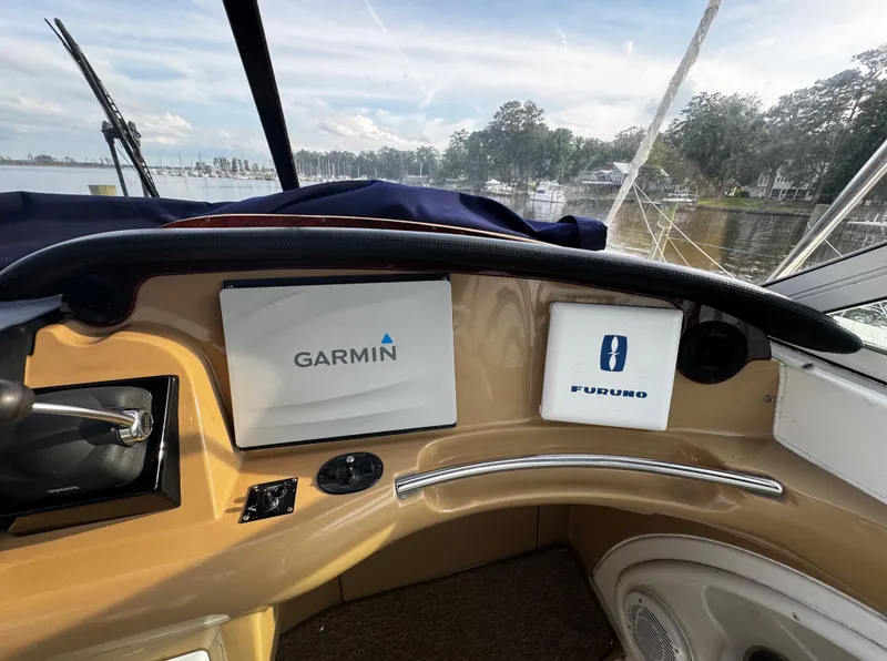 Slide: The Image of 2001 Carver 466 Motor Yacht dashboard with Garmin and Furuno navigation systems. - 29