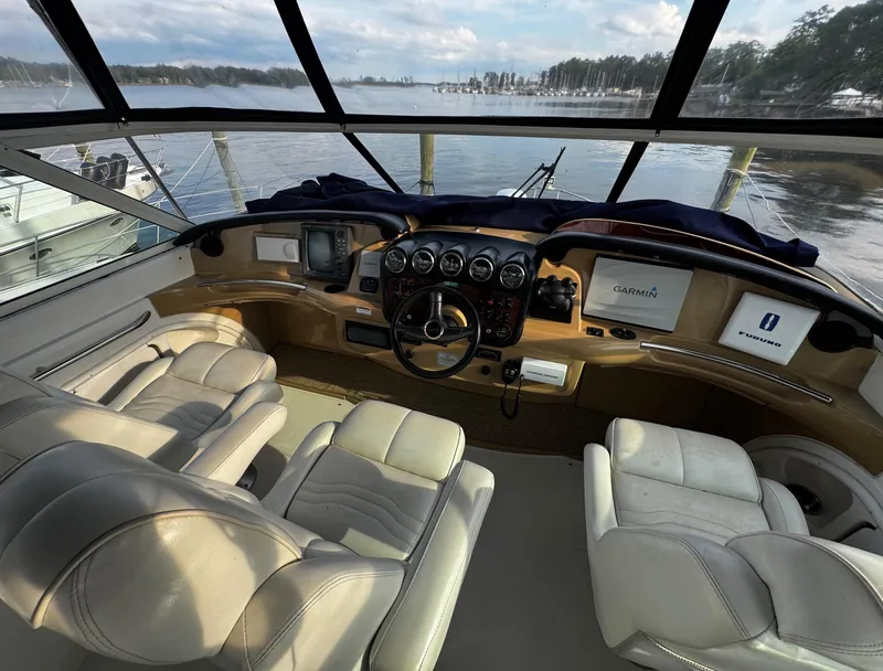 Slide: The Image of Interior view of 2001 Carver 466 Motor Yacht cockpit with leather seats and control panel. - 32