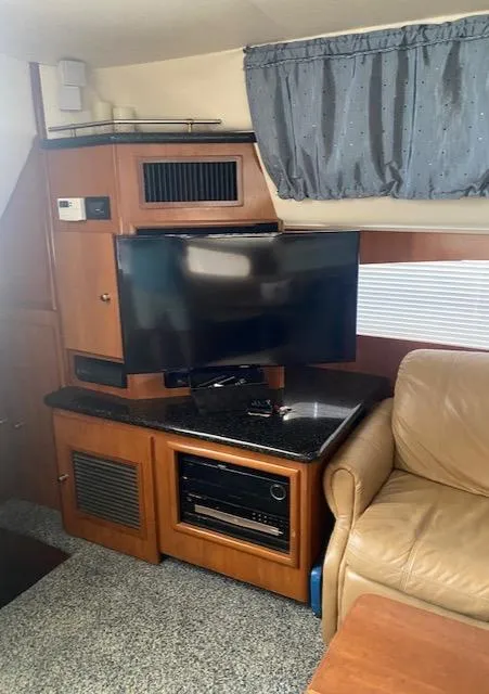 Slide: The Image of Interior of 2001 Carver 466 Motor Yacht with TV, leather seating, and wood cabinetry. - 39