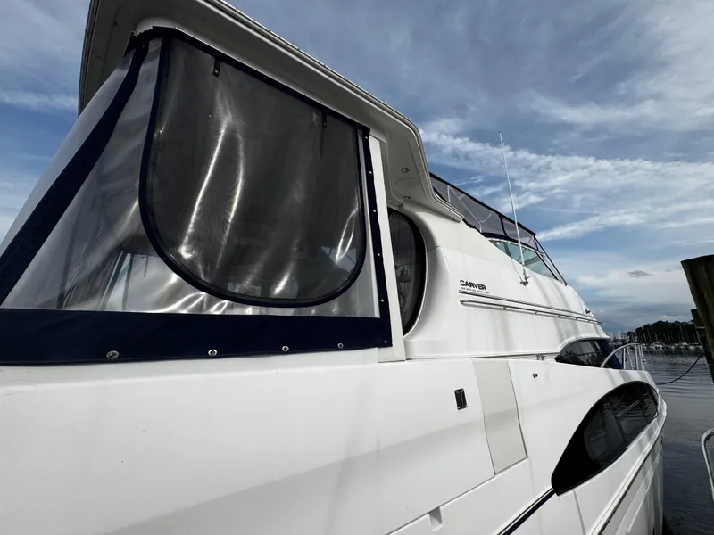 Slide: The Image of 2001 Carver 466 Motor Yacht docked under a cloudy sky. - 5