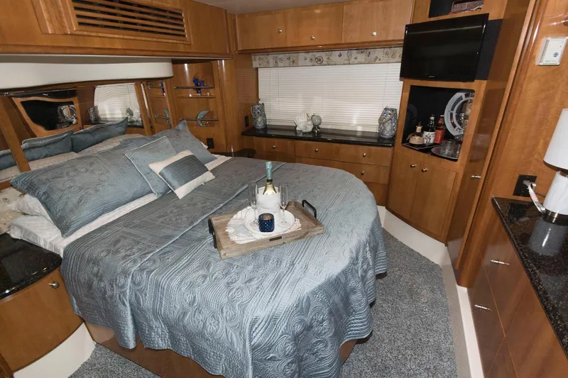 Slide: The Image of Luxurious bedroom interior of 2001 Carver 466 Motor Yacht with elegant bedding and decor. - 75