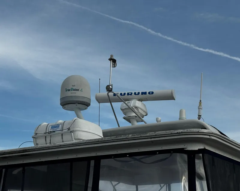 Slide: The Image of Radar and communication equipment on a 2001 Carver 466 Motor Yacht against a clear sky. - 13