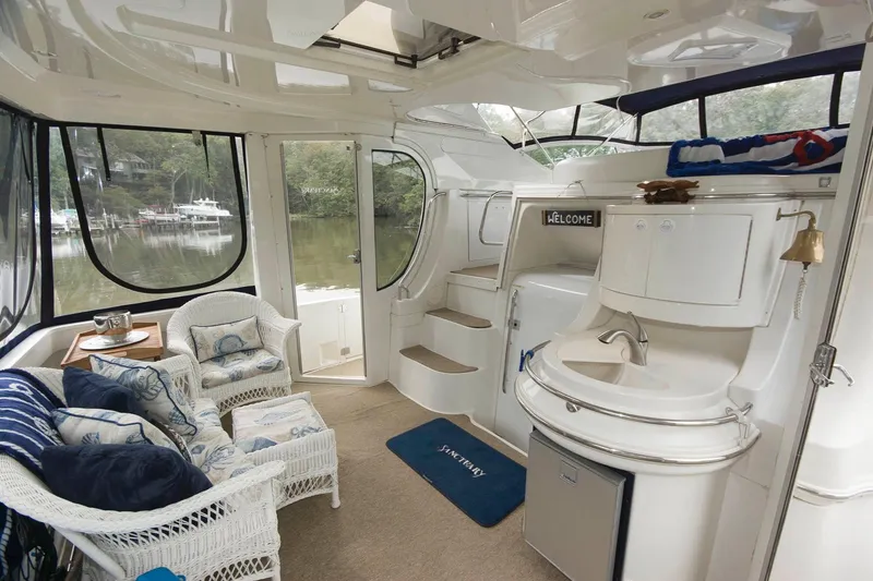 Slide: The Image of Interior of 2001 Carver 466 Motor Yacht with wicker seating and kitchenette. - 16