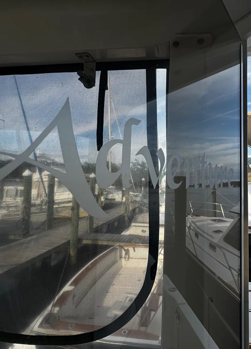 Slide: The Image of 2001 Carver 466 Motor Yacht docked, featuring "Adventure" text on window. - 17