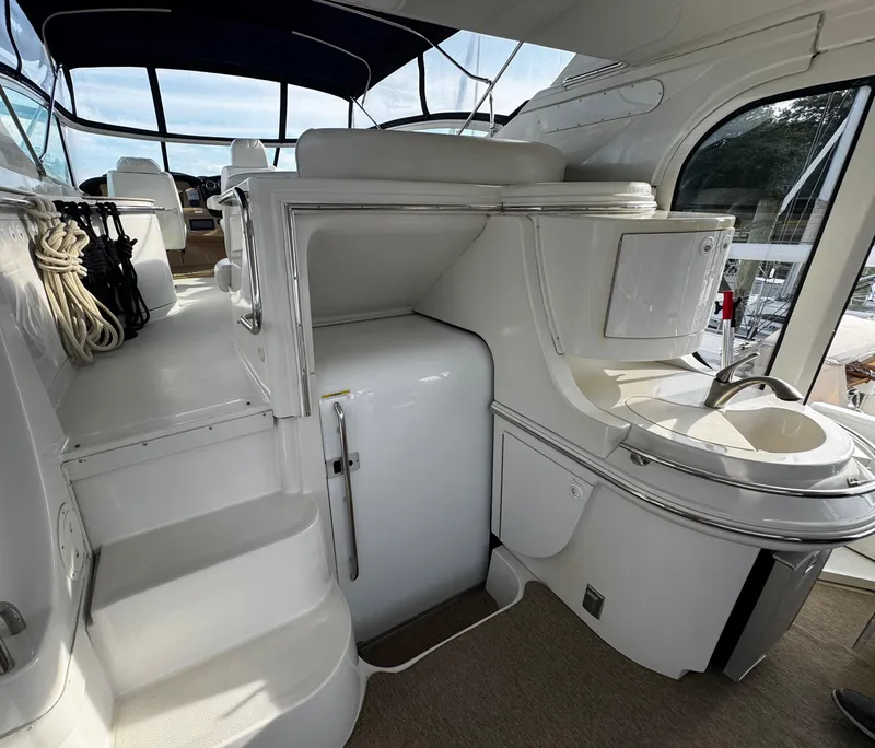 Slide: The Image of 2001 Carver 466 Motor Yacht interior with kitchenette and seating area. - 23
