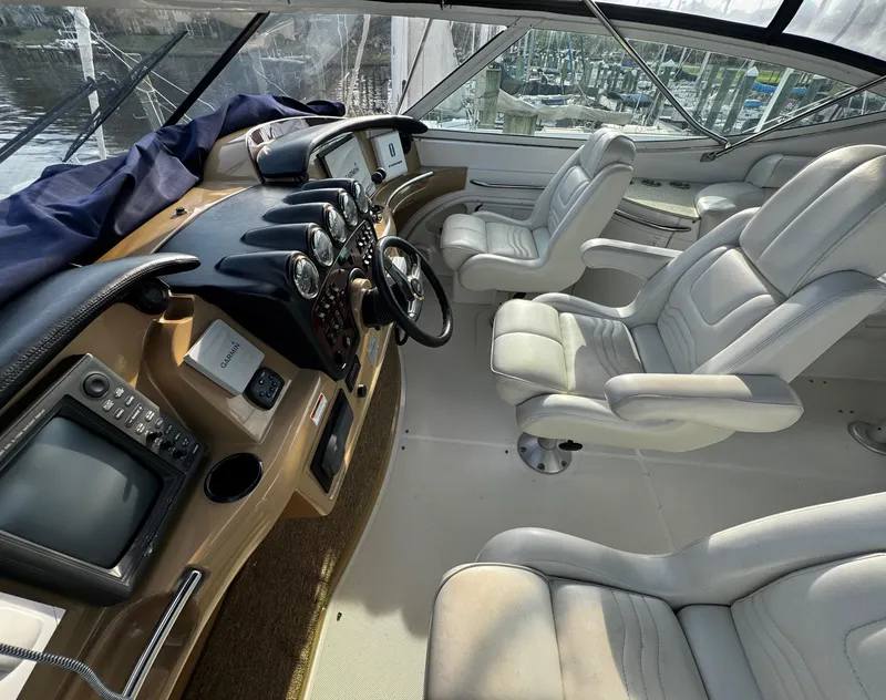 Slide: The Image of 2001 Carver 466 Motor Yacht cockpit with leather seats and navigation instruments. - 26