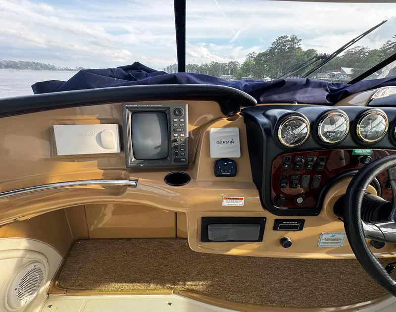 Slide: The Image of 2001 Carver 466 Motor Yacht helm with navigation instruments and steering wheel. - 28
