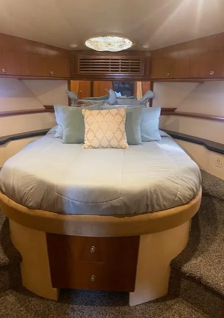 Slide: The Image of Luxurious bedroom in 2001 Carver 466 Motor Yacht with plush bedding and elegant wood accents. - 54