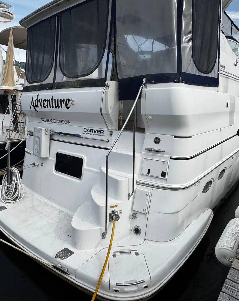 Slide: The Image of 2001 Carver 466 Motor Yacht docked, featuring "Adventure" on the stern. - 6